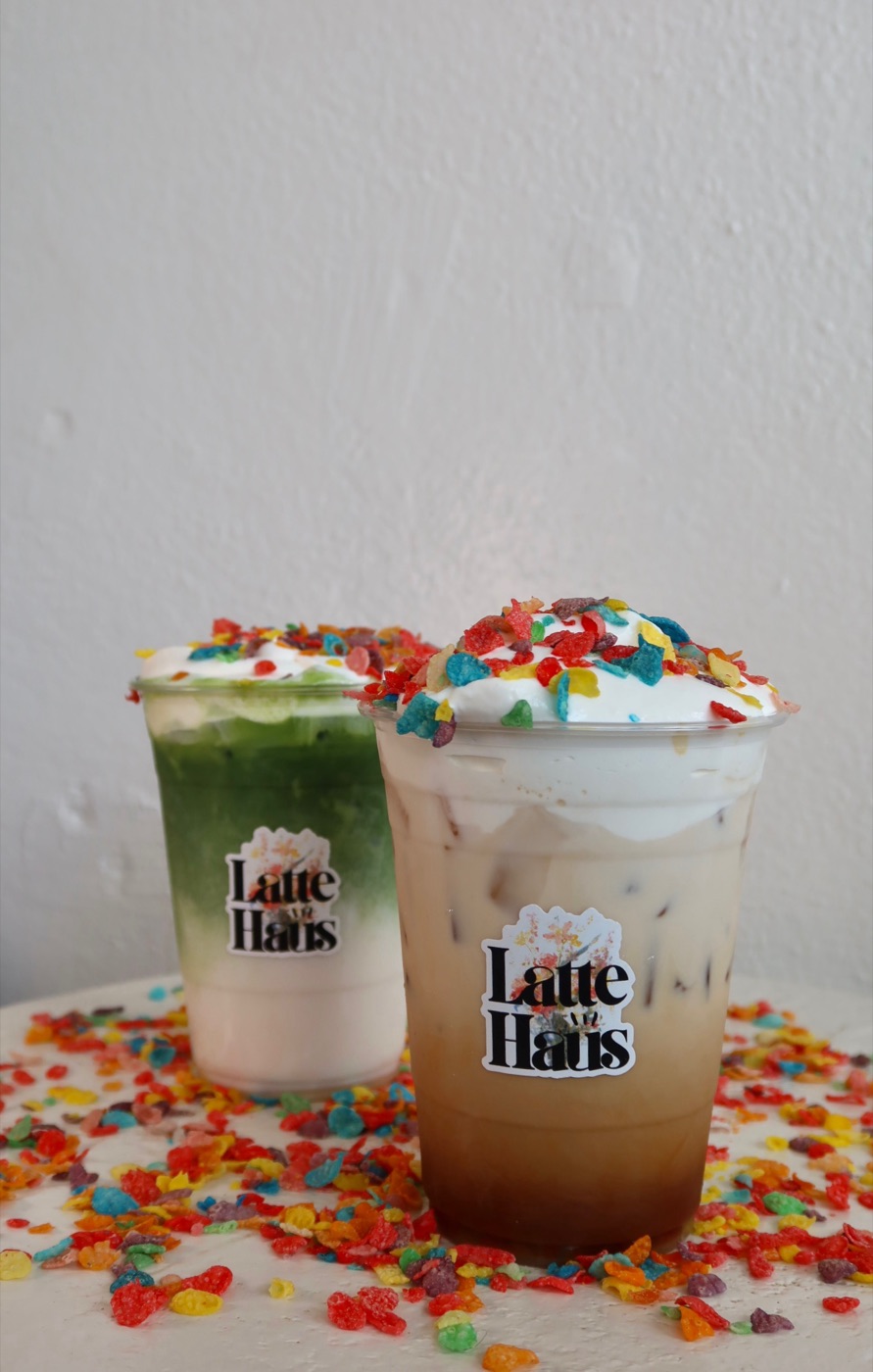 Fruity Pebbles Lattes topped with whipped cream and cereal at Latte Haus