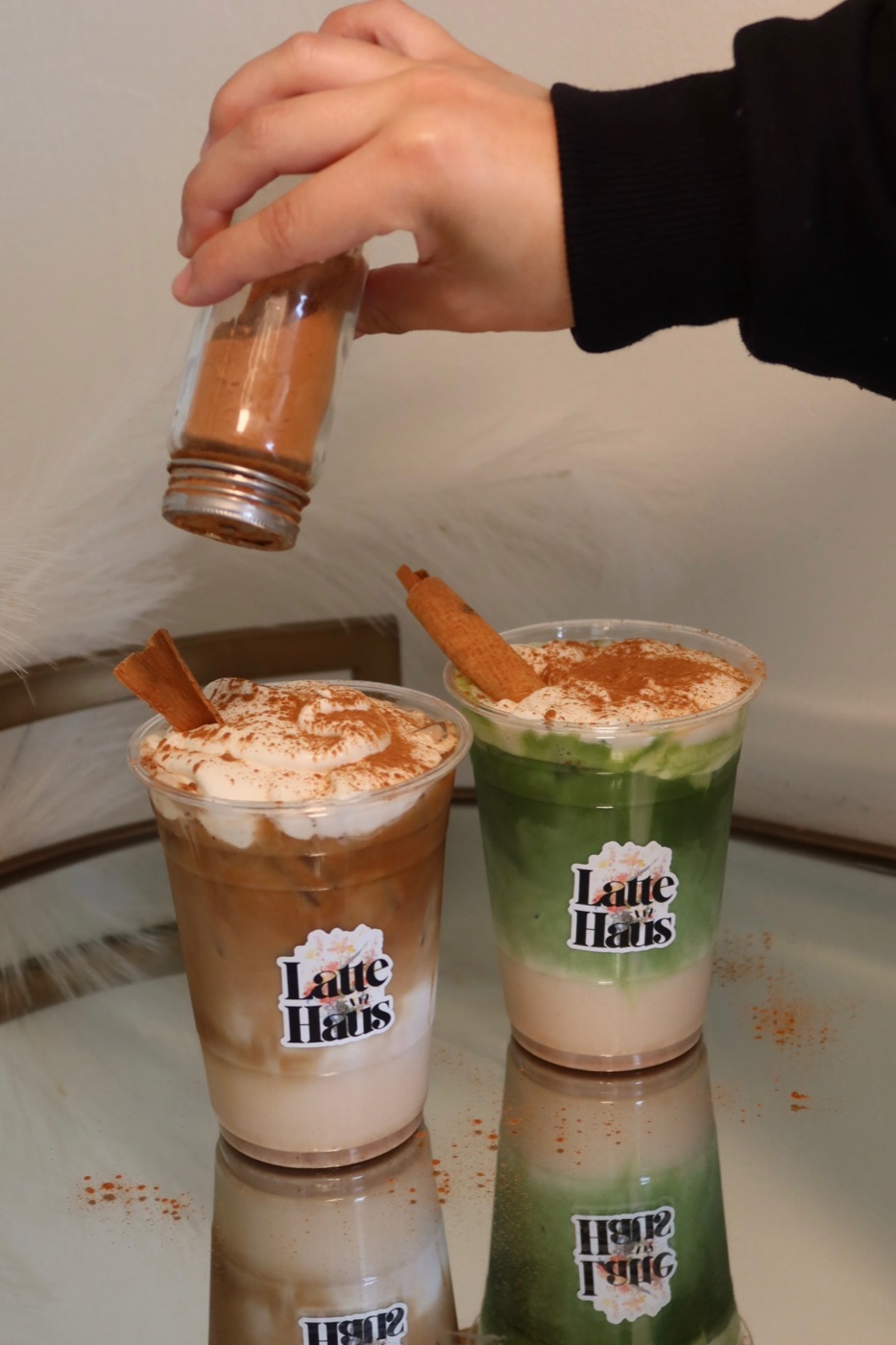 Cinnamon being sprinkled over Horchata Lattes at Latte Haus