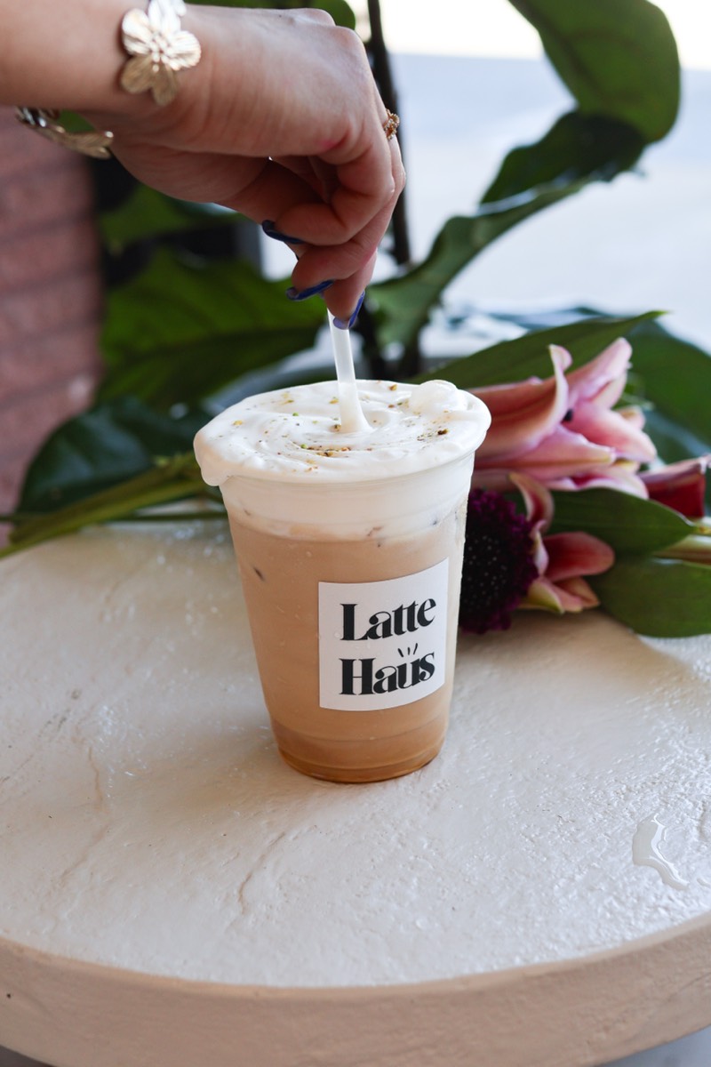 Iced latte being stirred at Latte Haus