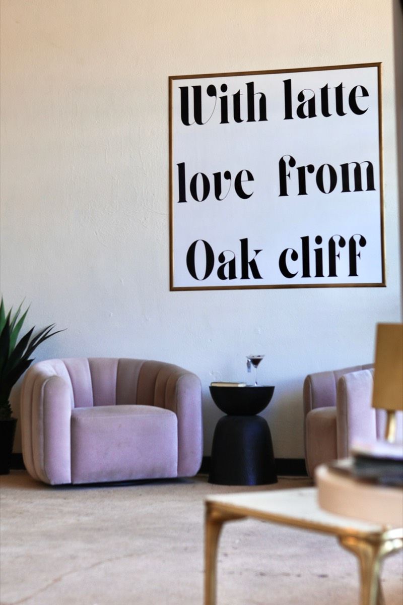 With Latte Love from Oak Cliff sign inside Latte Haus with pink velvet chairs